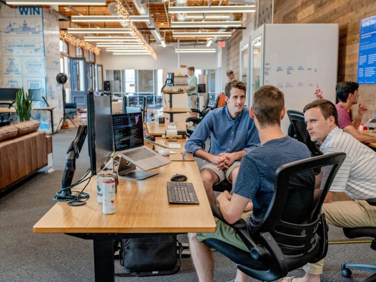 A group gathers around a trendy office table