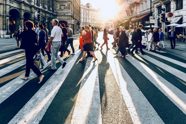 Lots of people cross at pedestrian crossing.