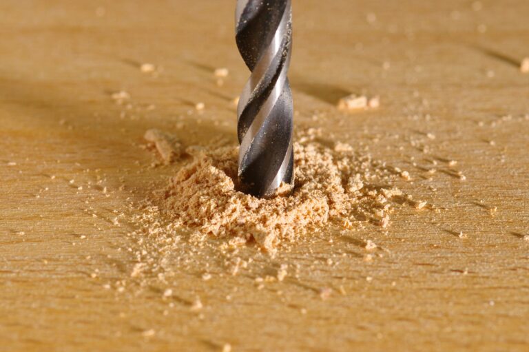 Close up of drill boring into wood