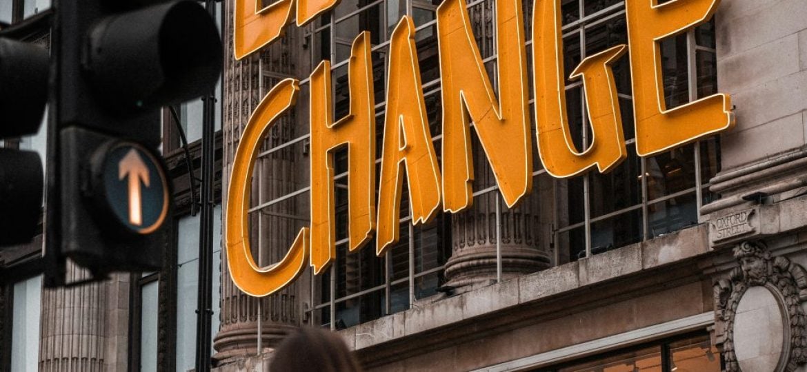 A sign on the side of a building says "let's change".