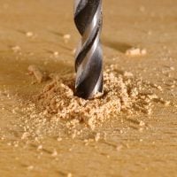 Close up of drill boring into wood