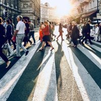 Lots of people cross at pedestrian crossing.